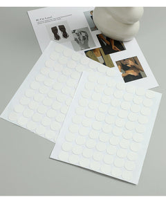 Multiple adhesive dots on a surface