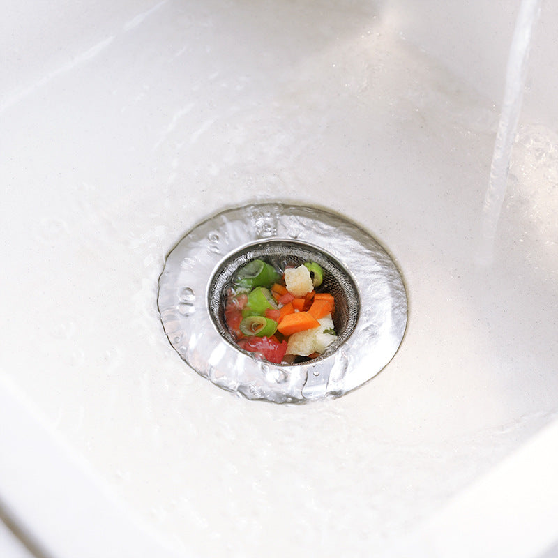 Kitchen sink with installed stainless steel strainer preventing clogs