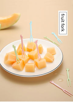colorful disposable forks on a table with fruits