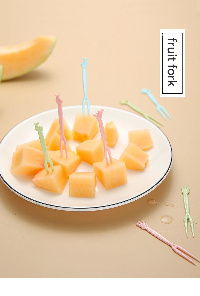 colorful disposable forks on a table with fruits