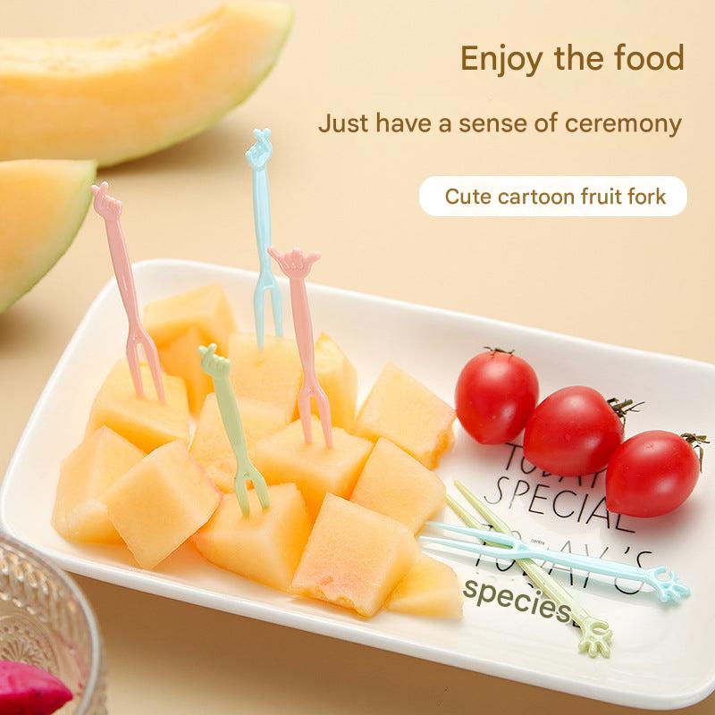 colorful disposable forks on a table with fruits