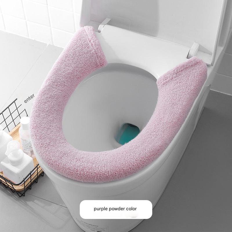 Toilet seat cover in simple bathroom setting