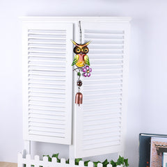 Detailed view of owl wind chime metal design