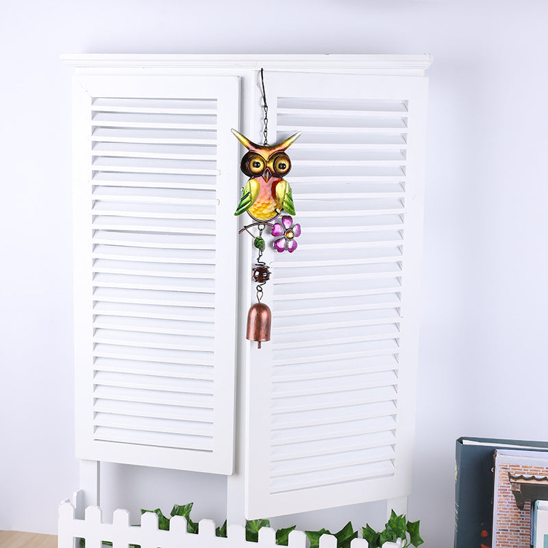 Detailed view of owl wind chime metal design