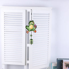 Close-up of colourful glass accents on frog wind chime
