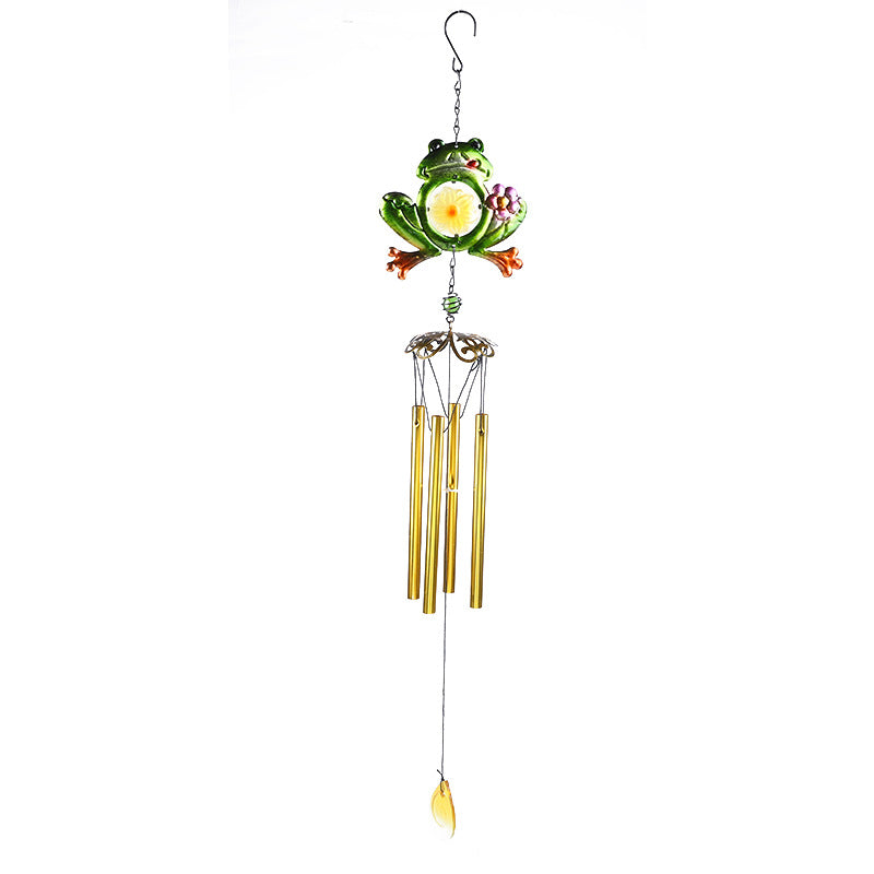 Frog wind chime swaying in gentle breeze outdoors