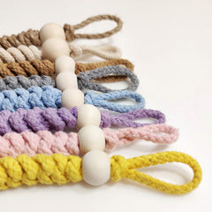 Natural beige rope toilet paper holder in bathroom setting