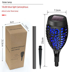 Solar garden torch highlighting outdoor decor