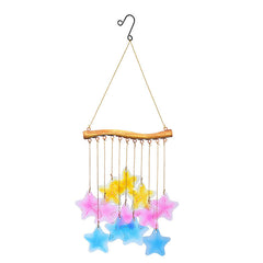 Colorful glass fish and leaf wind chime hanging in a garden