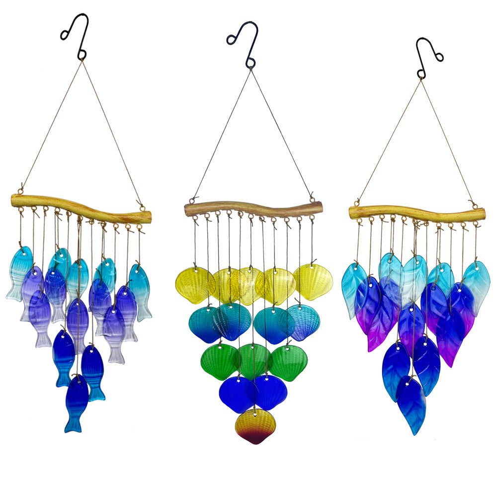 Detailed view of multi-coloured glass fish wind chime