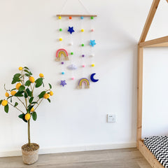 Kids' hair clips displayed on the wall in a colourful organiser