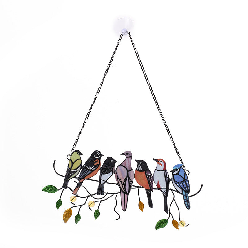 Close-up of colourful bird hangings against a backdrop