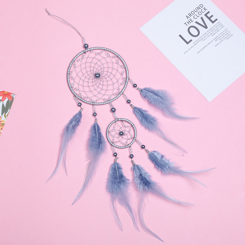 Multi-coloured dream catcher hanging on the wall
