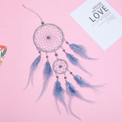 Multi-coloured dream catcher hanging on the wall