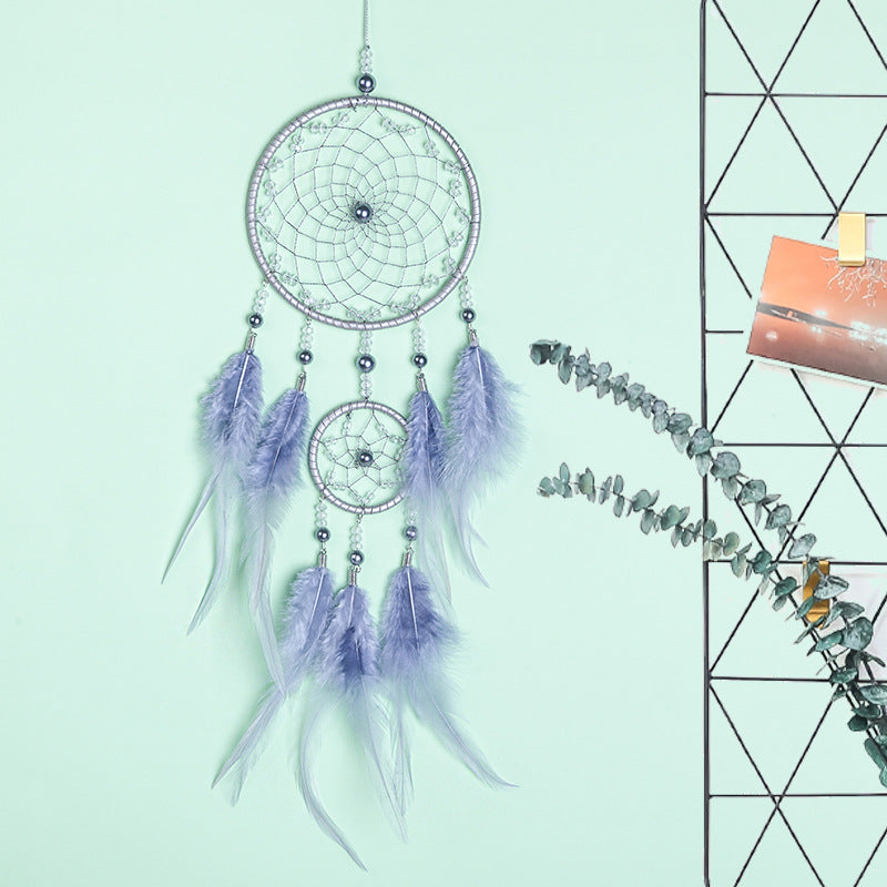 Enchanting dream catcher featuring beads and feathers