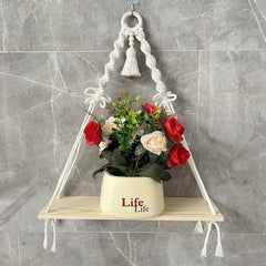 Macrame planter shelf displaying candles outdoors