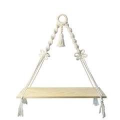 Decorative macrame shelf holding plants indoors