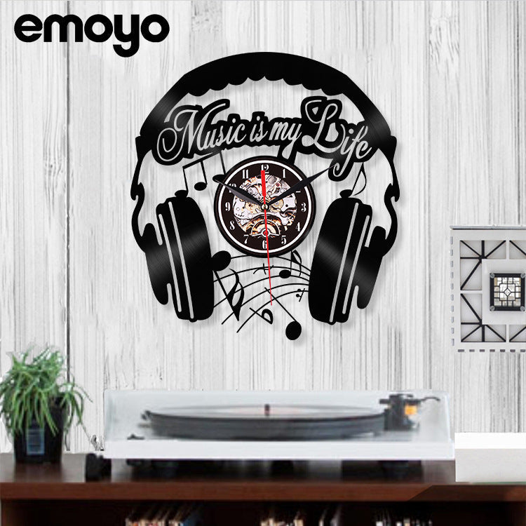 Luminous hands of the black vinyl clock in the dark