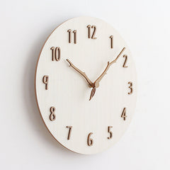 Elegant wooden wall clock against a neutral backdrop
