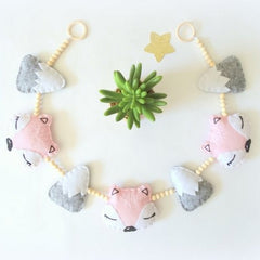 Wooden bead decoration over a crib