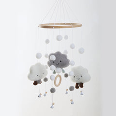 Colourful pom poms on cloud mobile for kids room