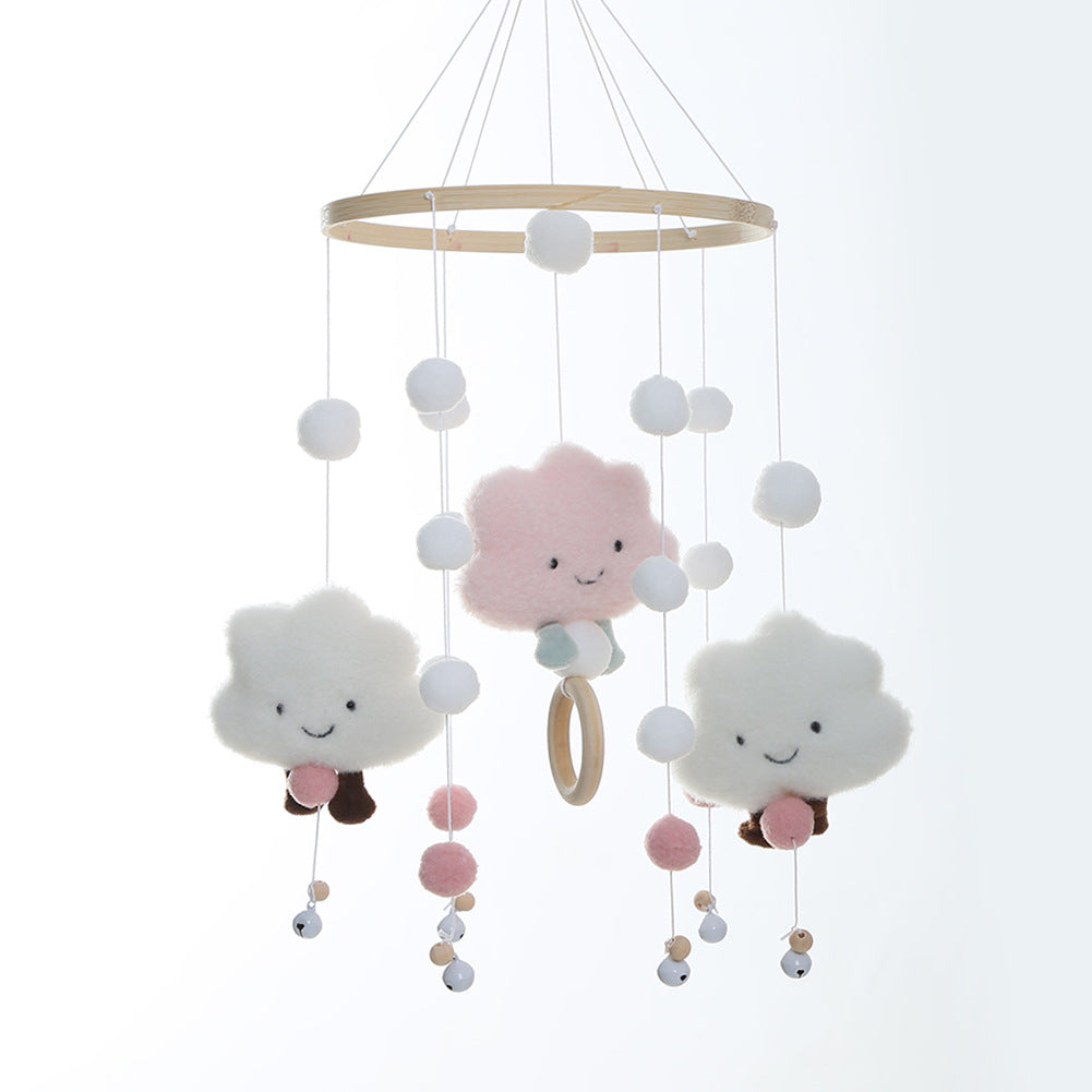 Close-up of whimsical cloud and pom pom mobile decoration