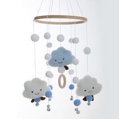 Whimsical cloud mobile displayed in a styled nursery