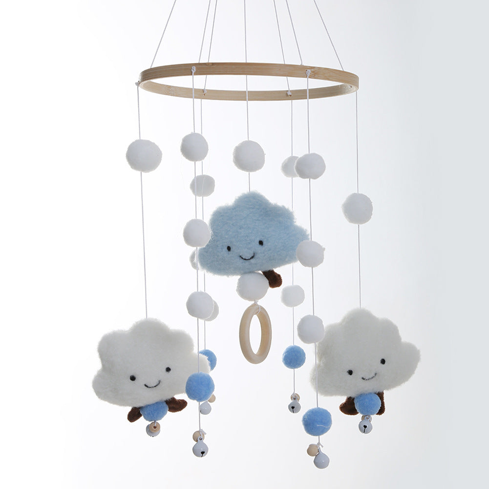 Whimsical cloud mobile displayed in a styled nursery