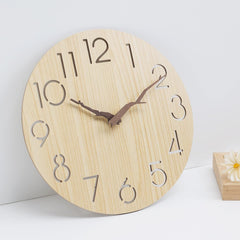 Walnut wood wall clock hanging on a wall