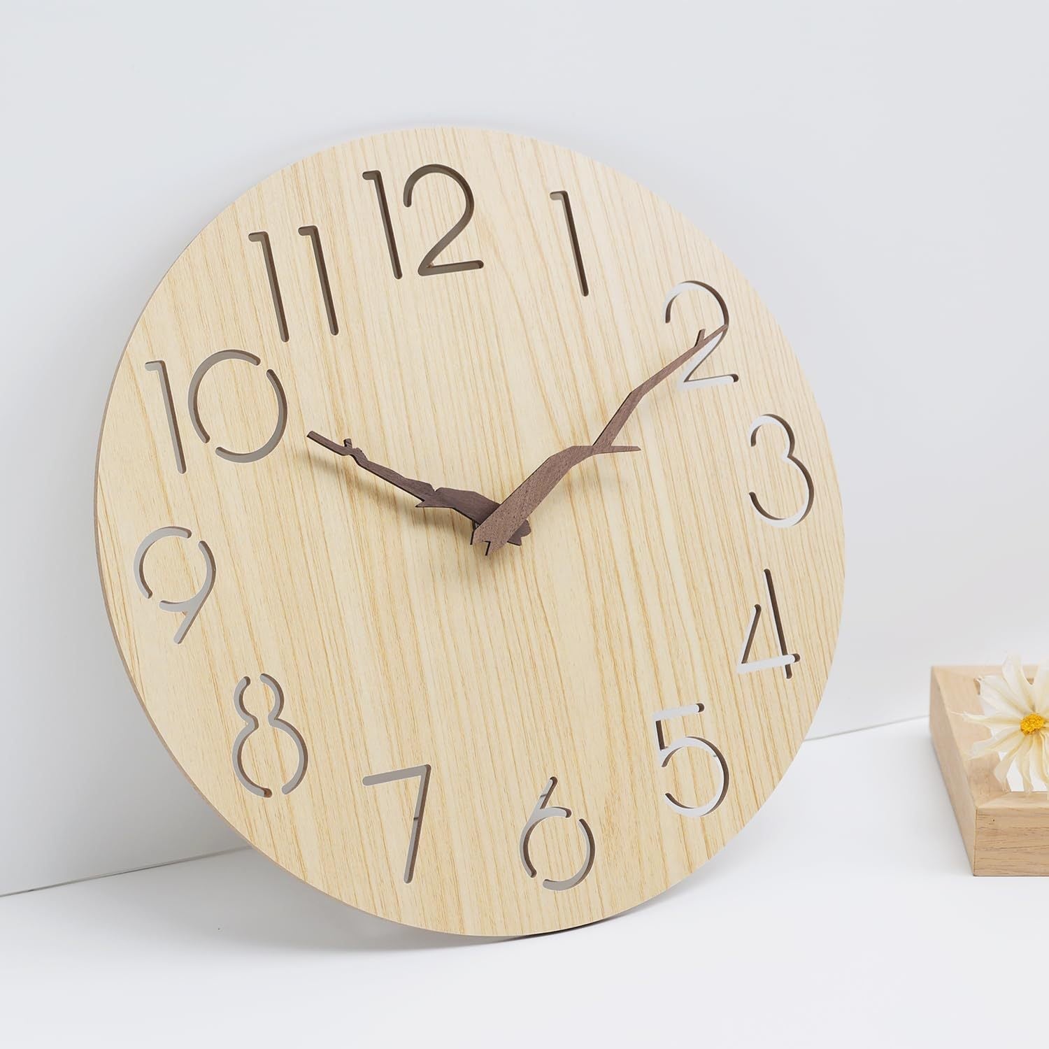 Walnut wood wall clock hanging on a wall