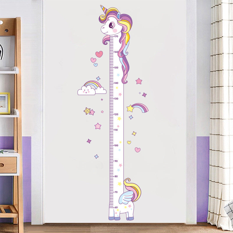 Kids measuring their height with unicorn chart