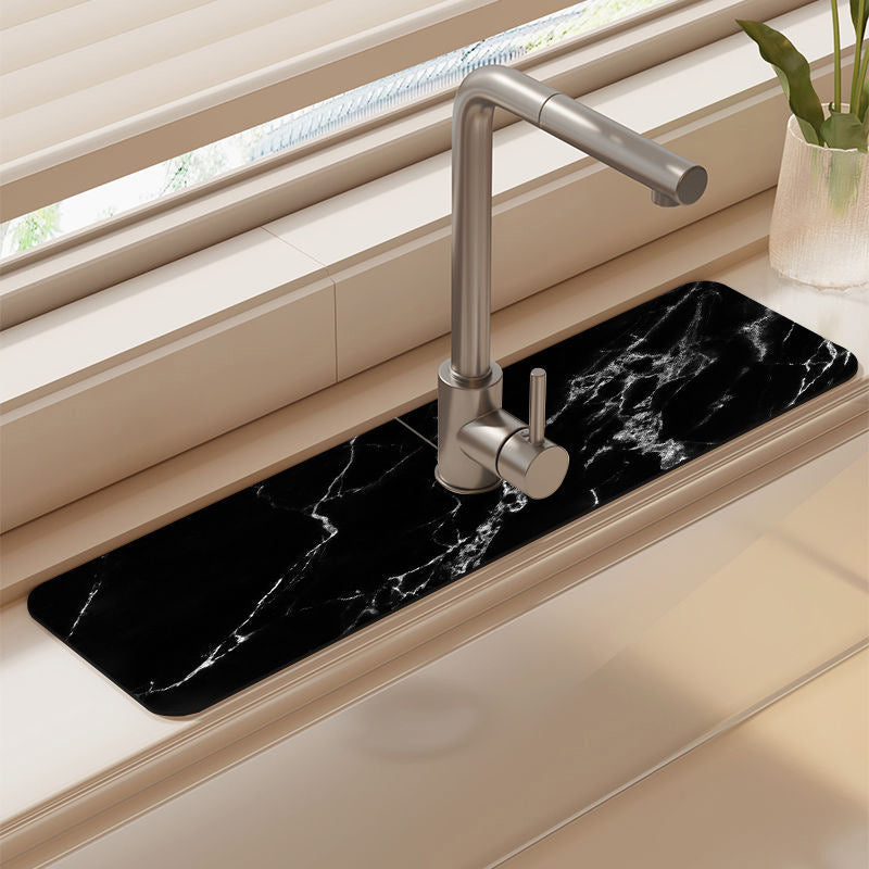 Quick-dry mat absorbing spill near a kitchen sink