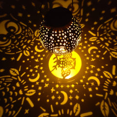 Owl projection light in a garden setting