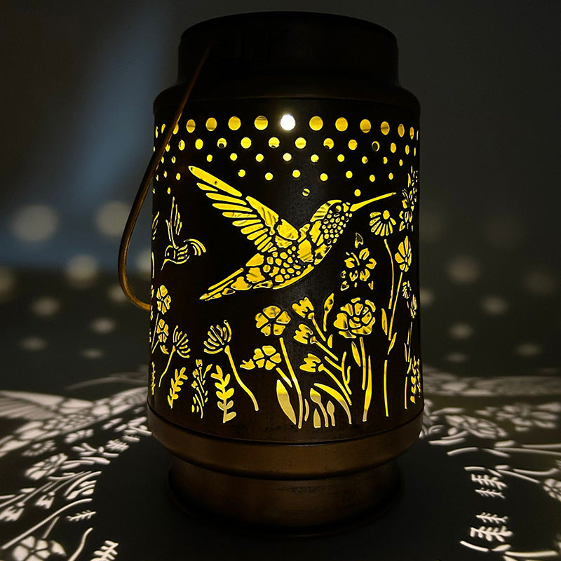 Hummingbird lantern illuminating patio