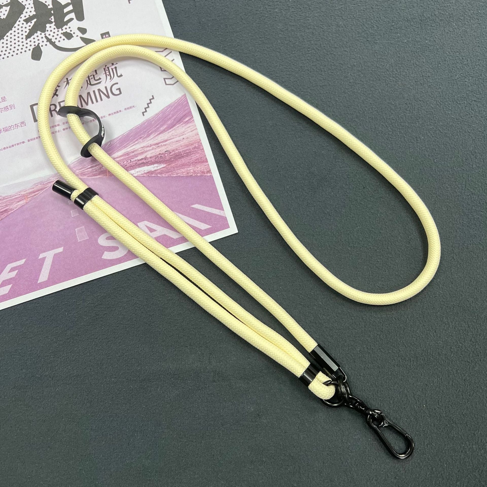 Mobile phone lanyard in a fashionable setting